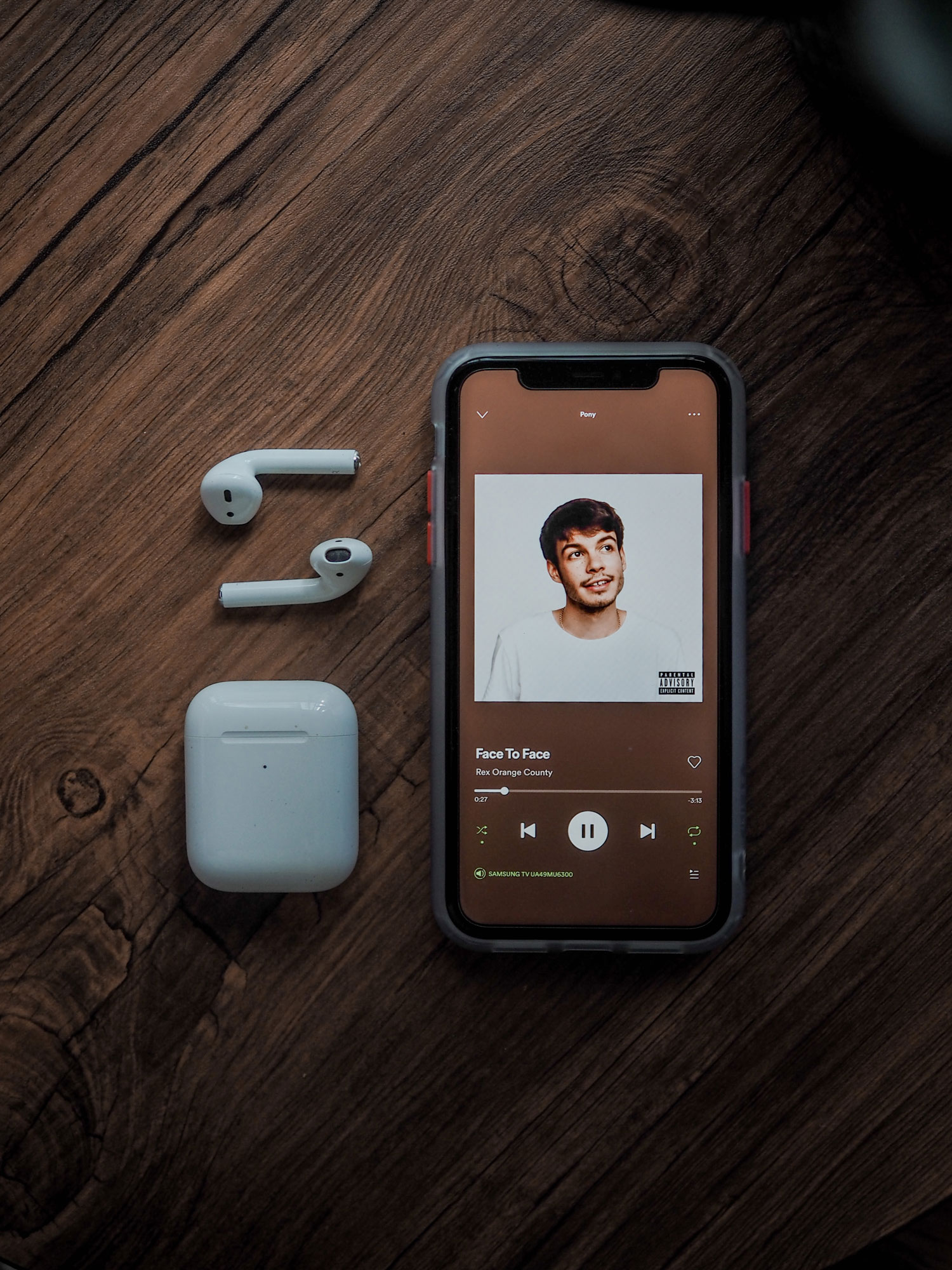 Free iPhone Mockup with AirPods on a Wooden Table - Free Mockup Download