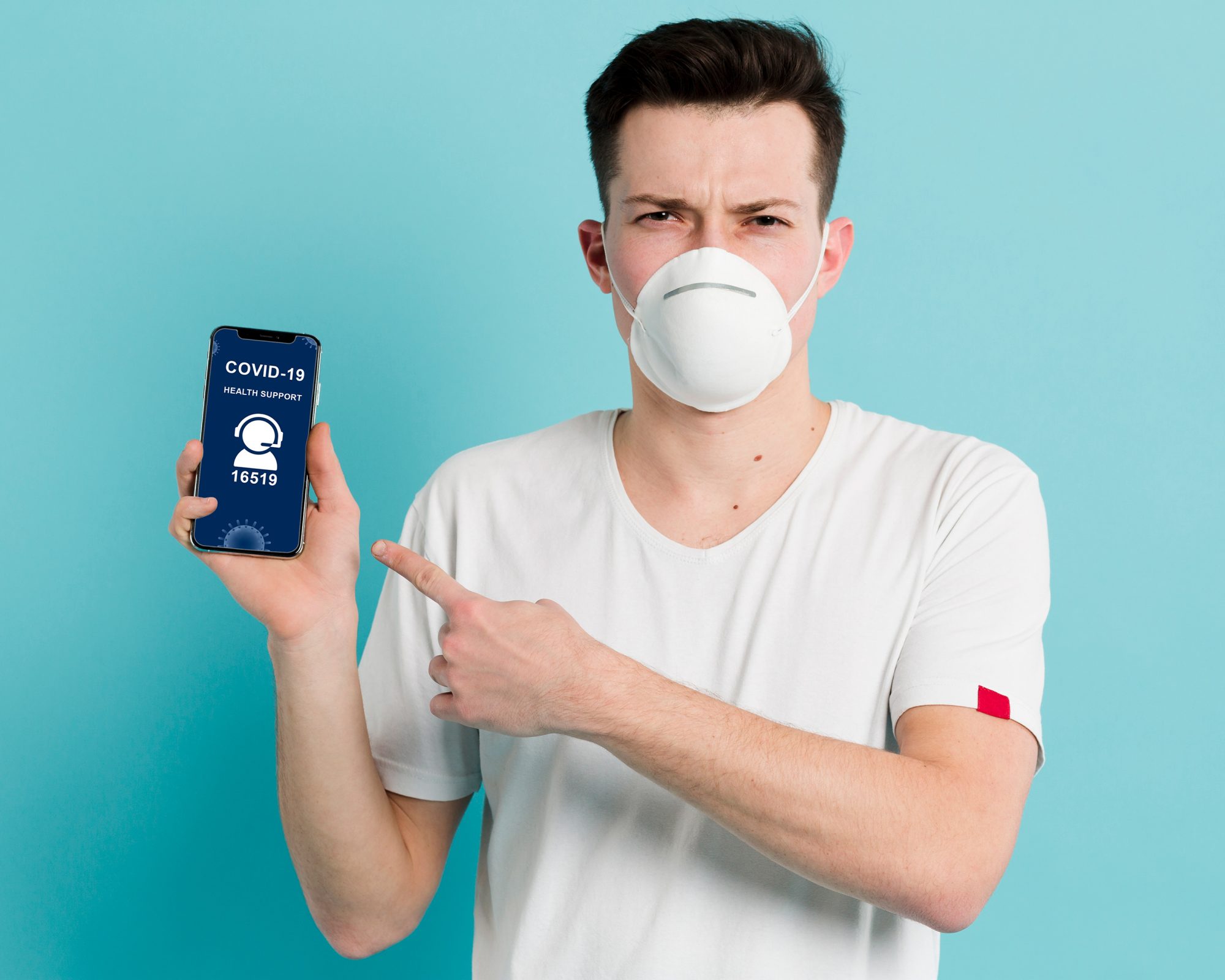 Man with a face mask holding an iPhone mockup