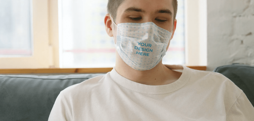 Man Wearing a Face Mask Reading a Book Free Mockup Generator
