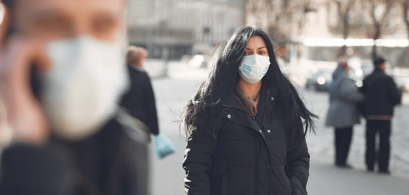 Woman Wearing a Face Mask Outdoors Free Mockup Generator