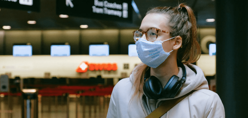 Woman Wearing a Face Mask at the Airport Free Mockup Generator