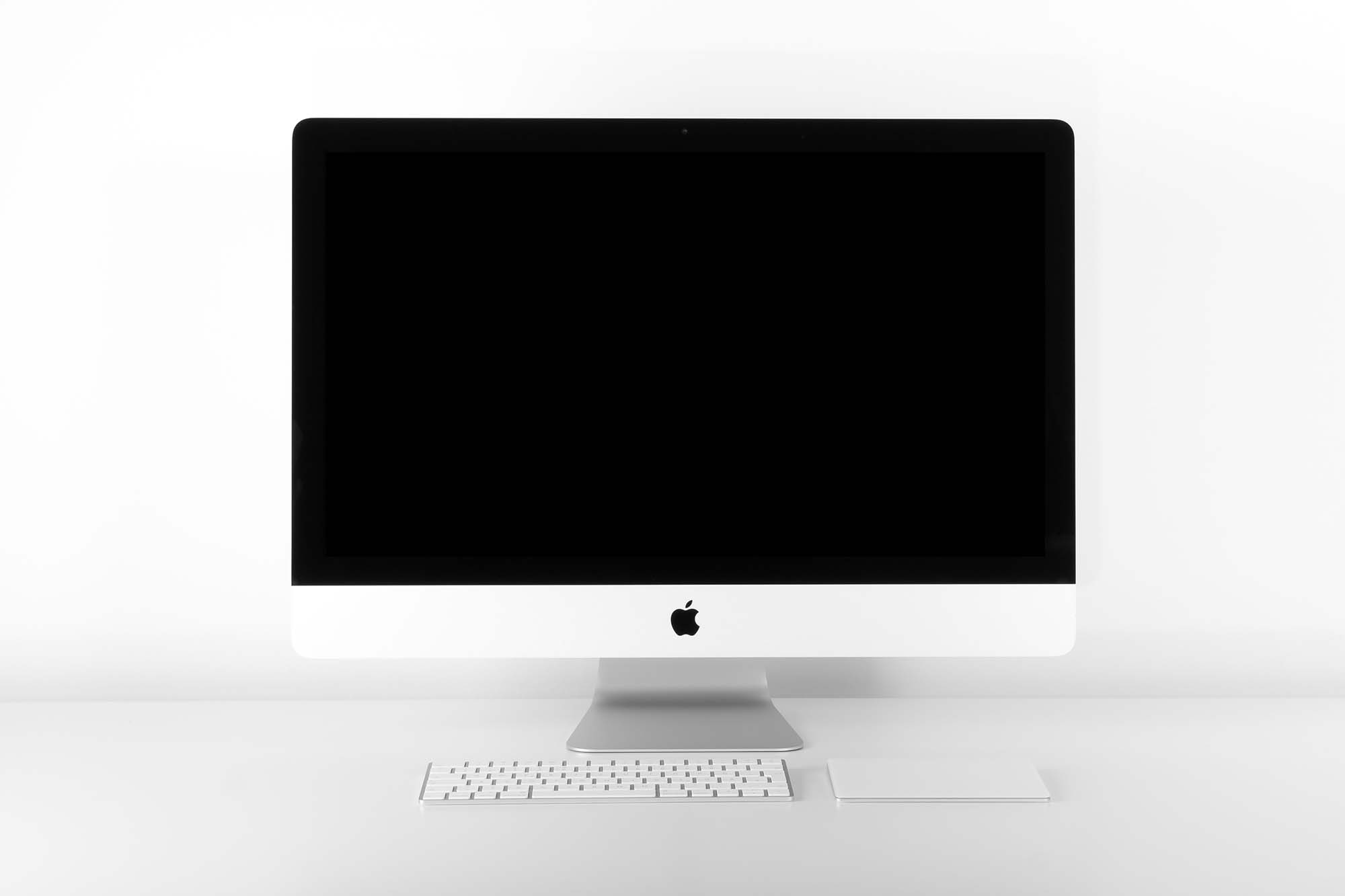 High-resolution iMac mockup on white background with keyboard and mouse, perfect for website design presentations.