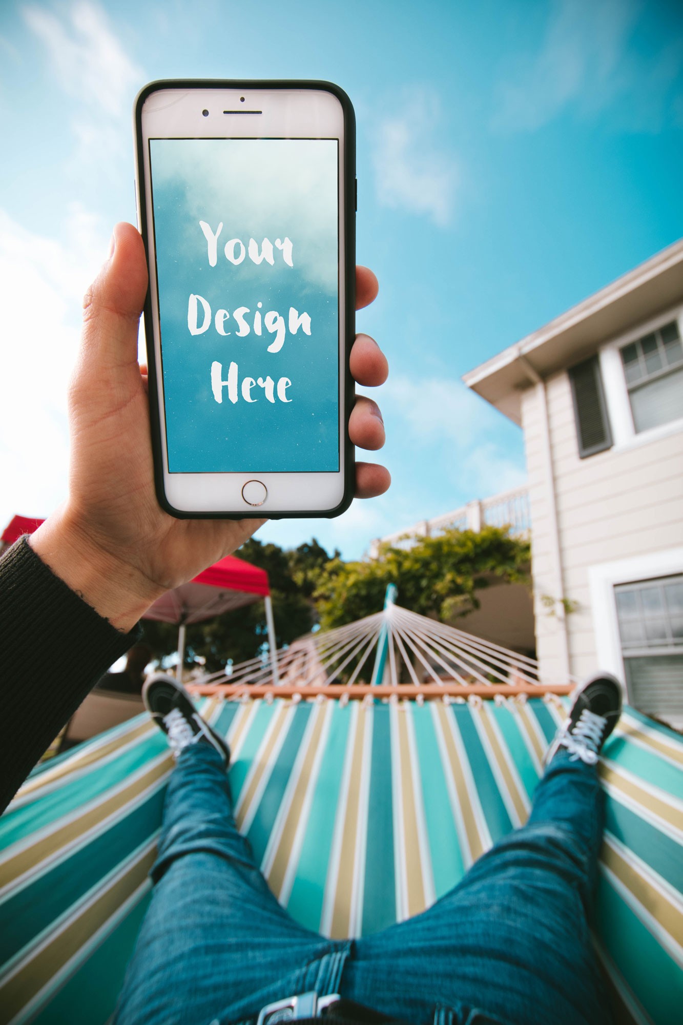 iPhone in the Hand of a Guy in a Hammock Free PSD Mockup