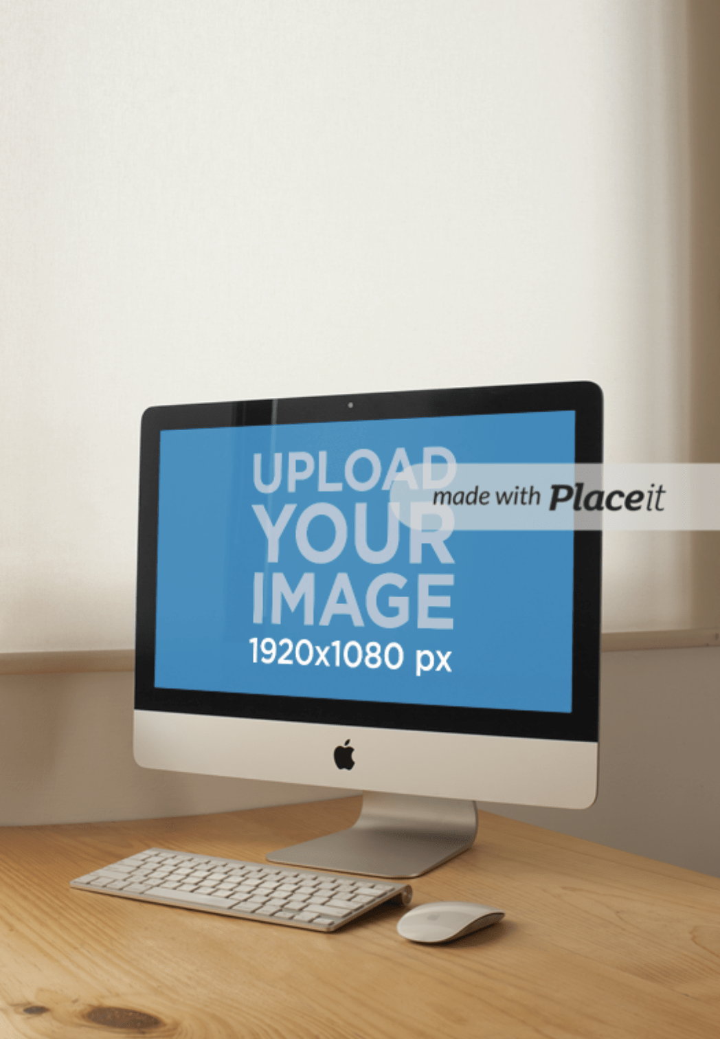 A vertical shot of an iMac with a keyboard and mouse on a wooden desk, awaiting your personalized design.