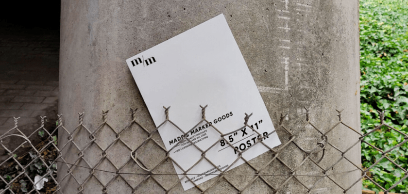 Urban Poster Mockup - Poster on a Concrete Pillar Behind a Chainlink Fence