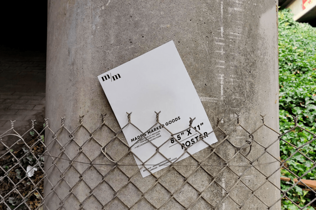 Urban Poster Mockup - Poster on a Concrete Pillar Behind a Chainlink Fence