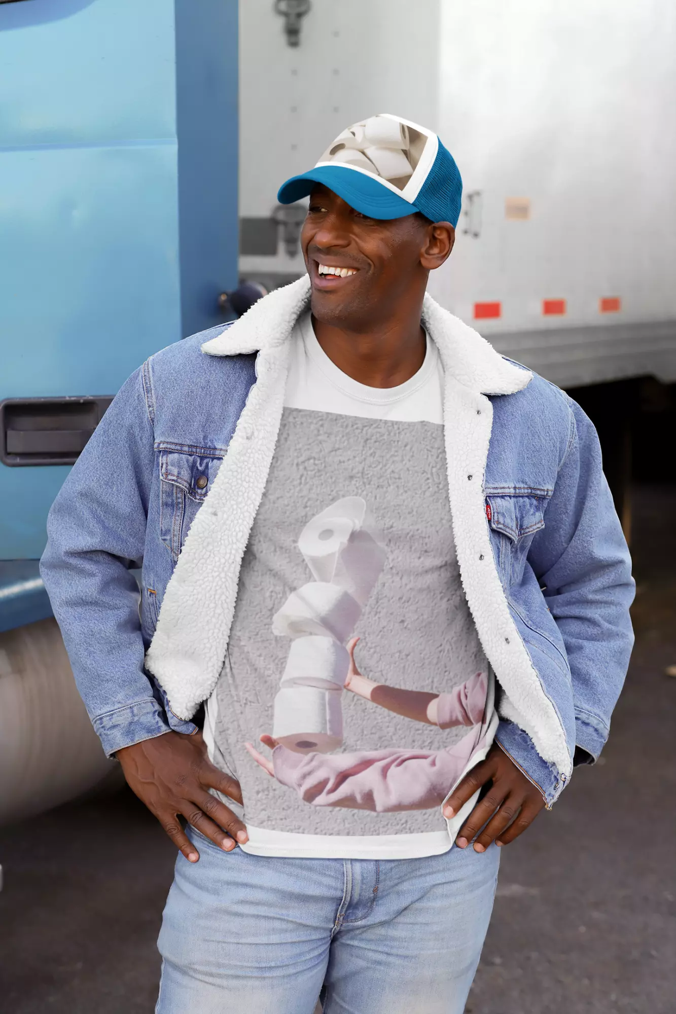 Mockup of a man with a customizable T-shirt and trucker hat on the street