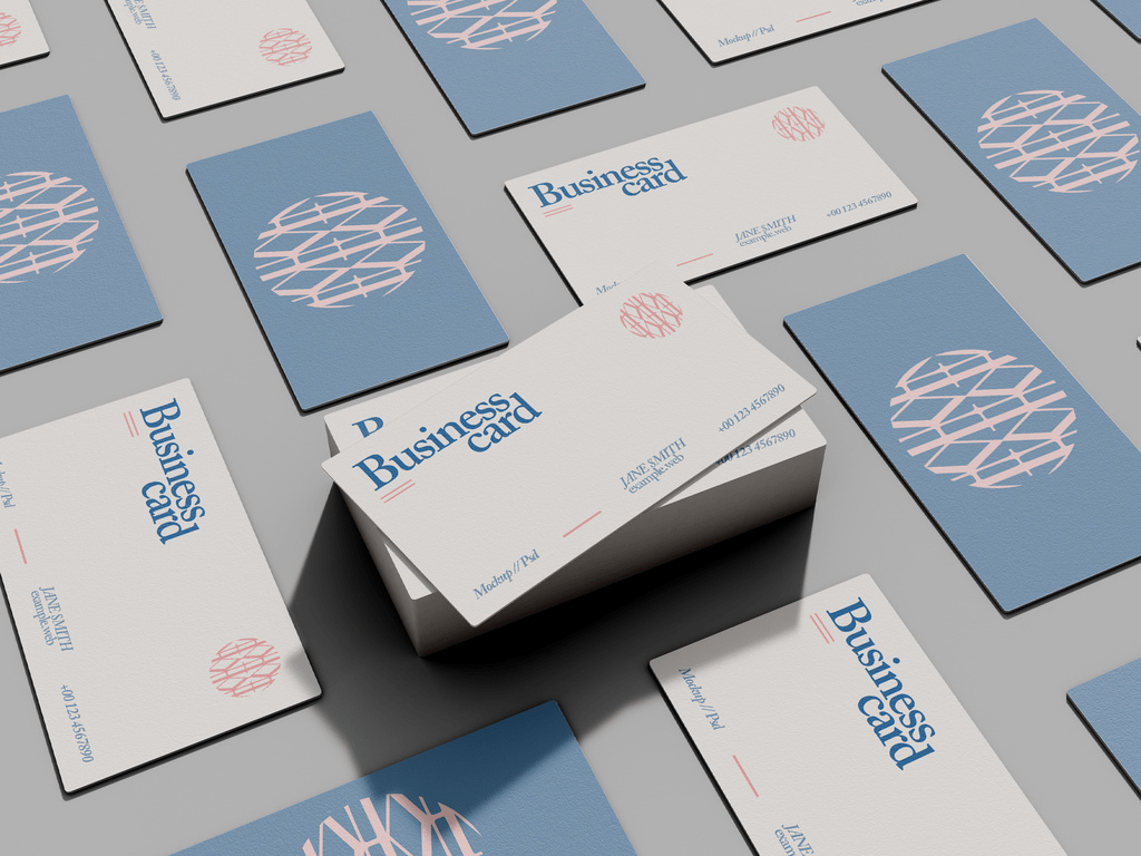 Assorted business cards in mosaic arrangement mockup featuring elegant blue and red design accents on a textured grey background.