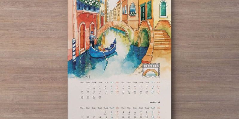 Portrait wall calendar mockup with a Venice illustration and monthly grids on a wood background