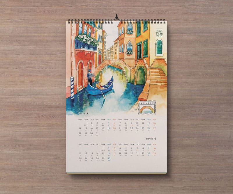 Portrait wall calendar mockup with a Venice illustration and monthly grids on a wood background